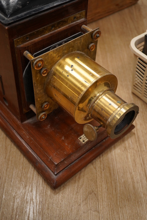 A mahogany and brass magic lantern in pine box, and a quantity of magic lantern slides by Primus, etc. Condition - poor to fair.